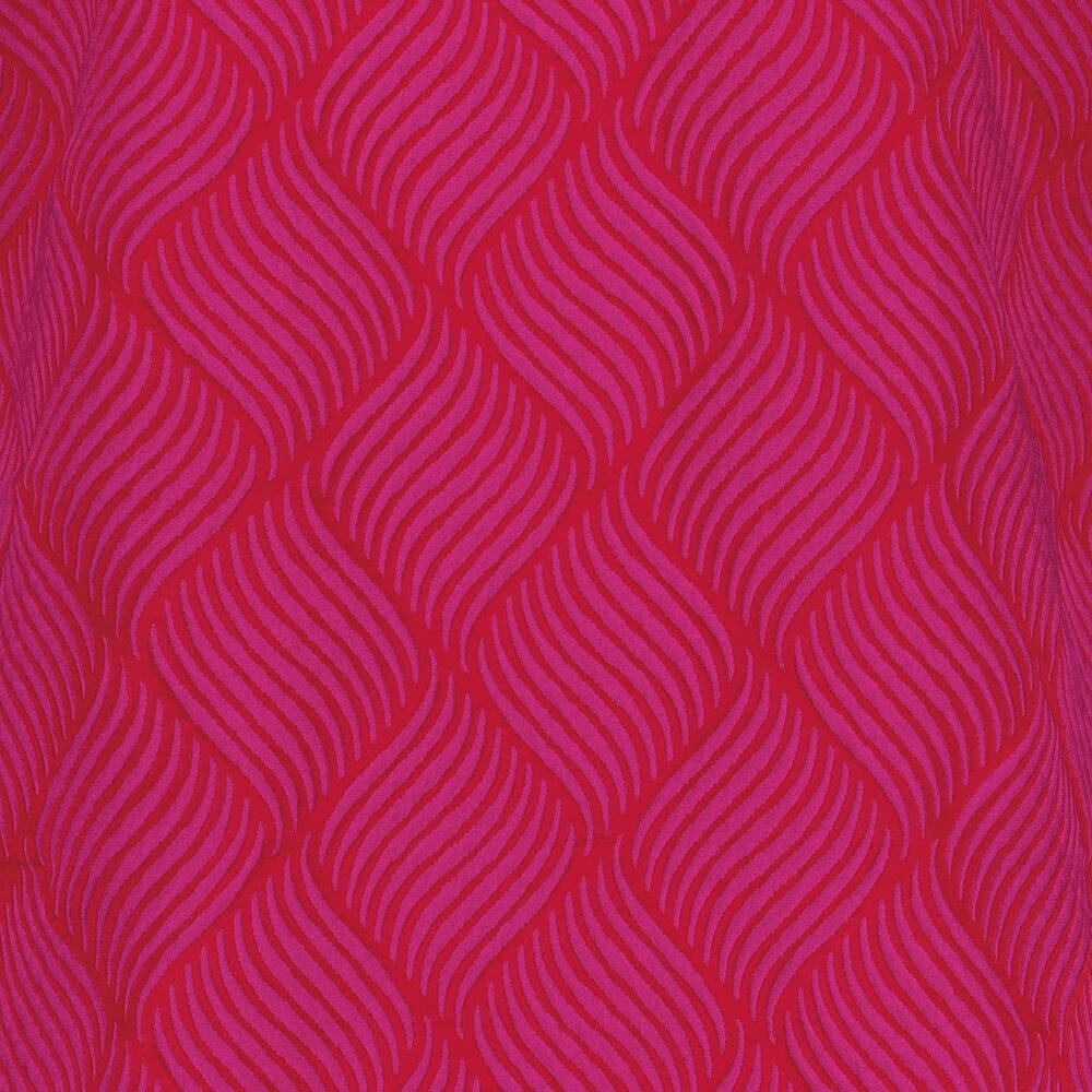 lähikuva pinkistä jacquard-kankaasta jossa on kuviointi pinkillä, oranssilla pohjalla